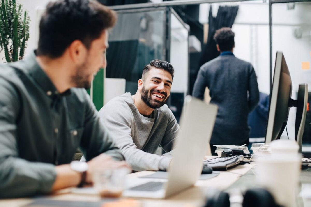 Two Coworkers Discussion at Desk