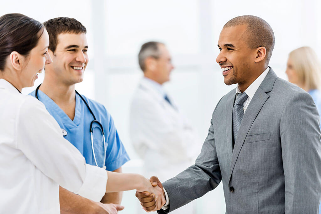 doctor shaking hands with man in suit