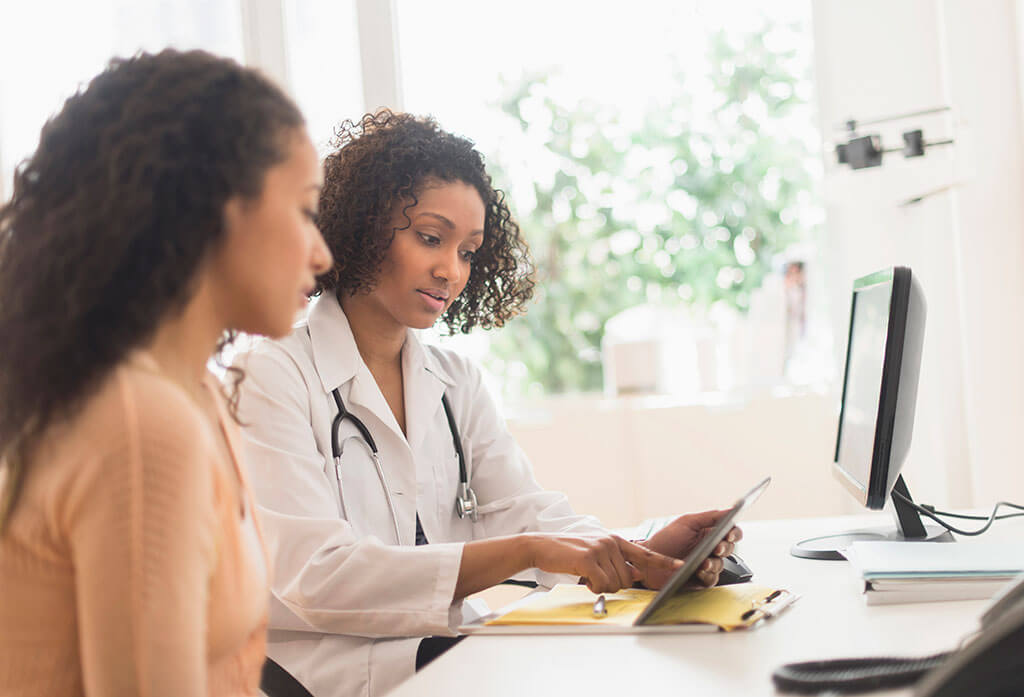Doctor and patient using tablet