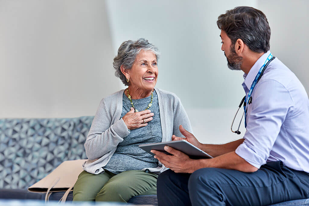 happy patient talking to doctor