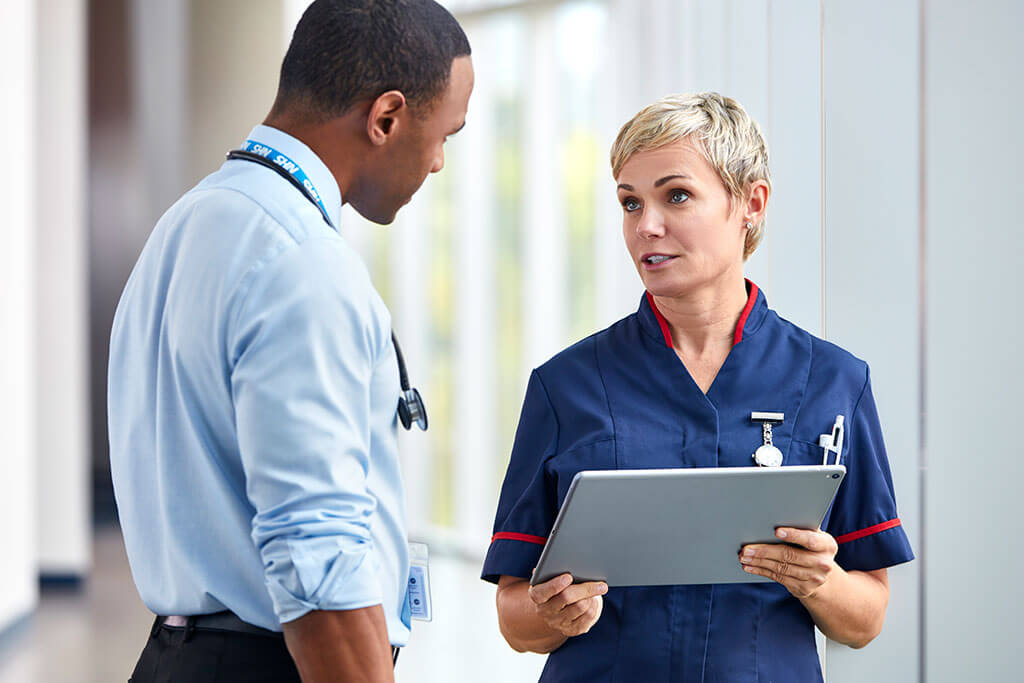 NHS nurse and doctor talking