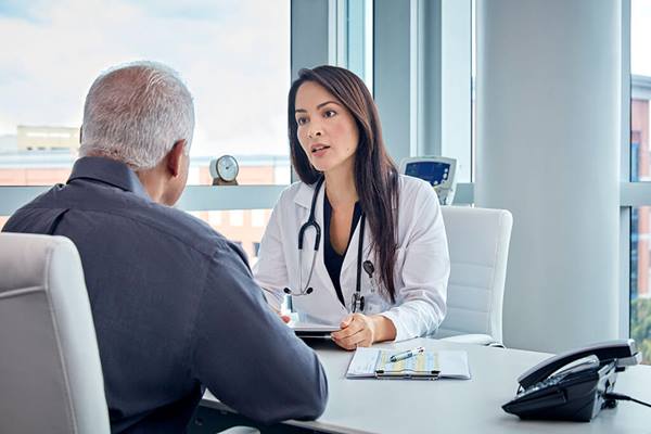 Healthcare professional talking to patient in office