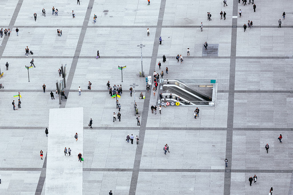 Crowds of people walking on the city square 