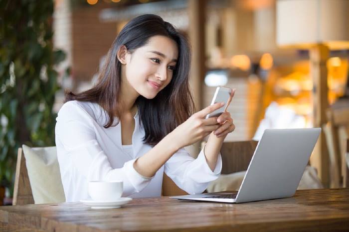 woman using smartphone in cafe