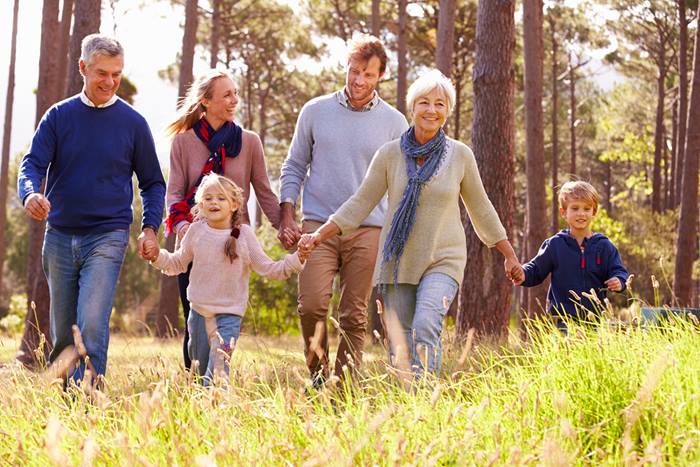 -Multigenerational family walking in field