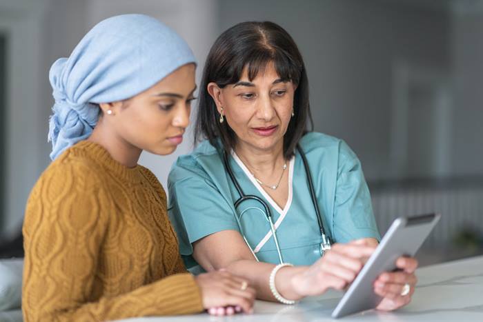 Doctor and patient viewing tablet