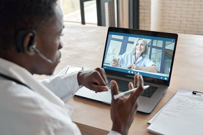 doctor consulting senior old patient by telemedicine online video call