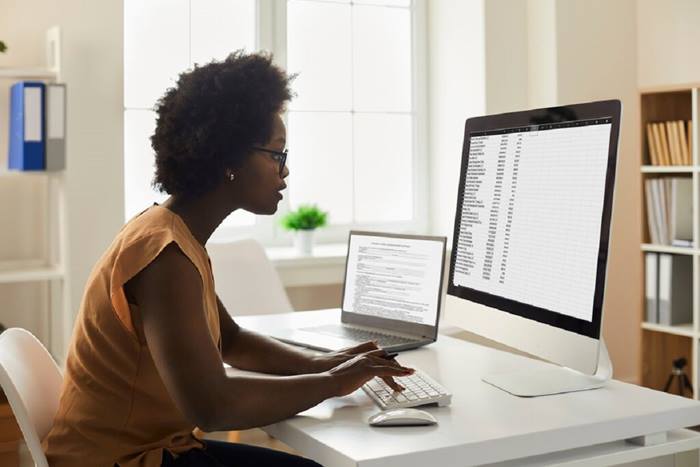 Employee studying data reports and spreadsheets