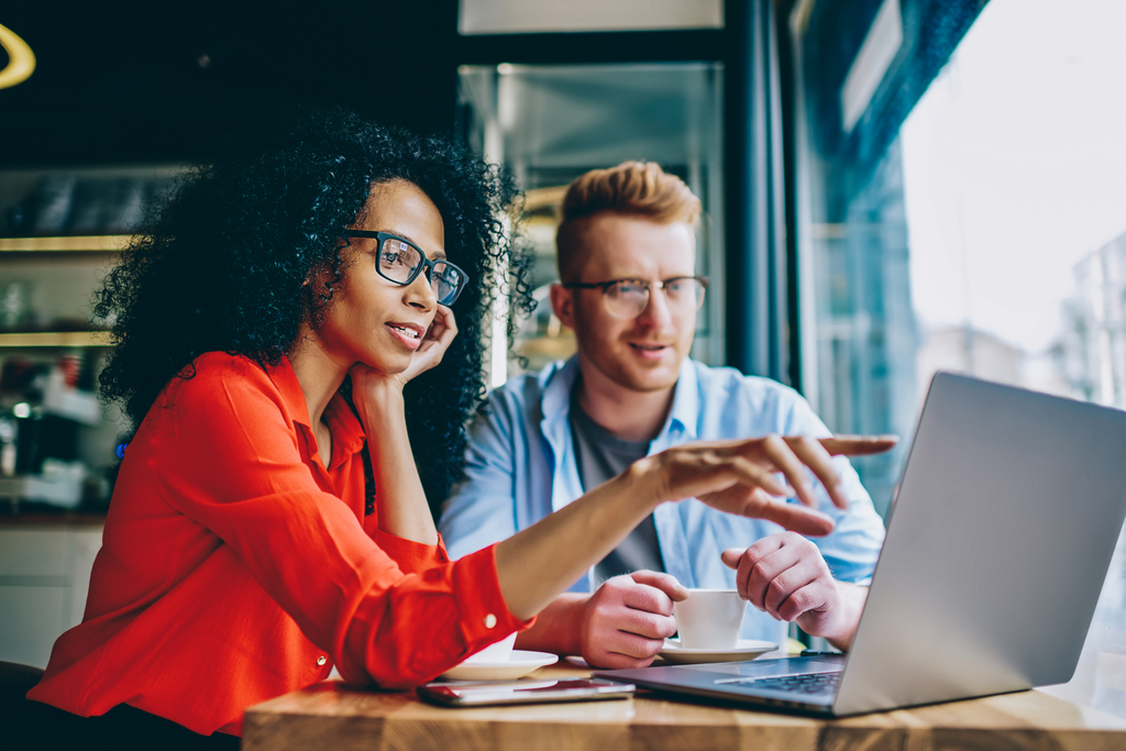 Woman pointing with finger on laptop computer during collaboration with