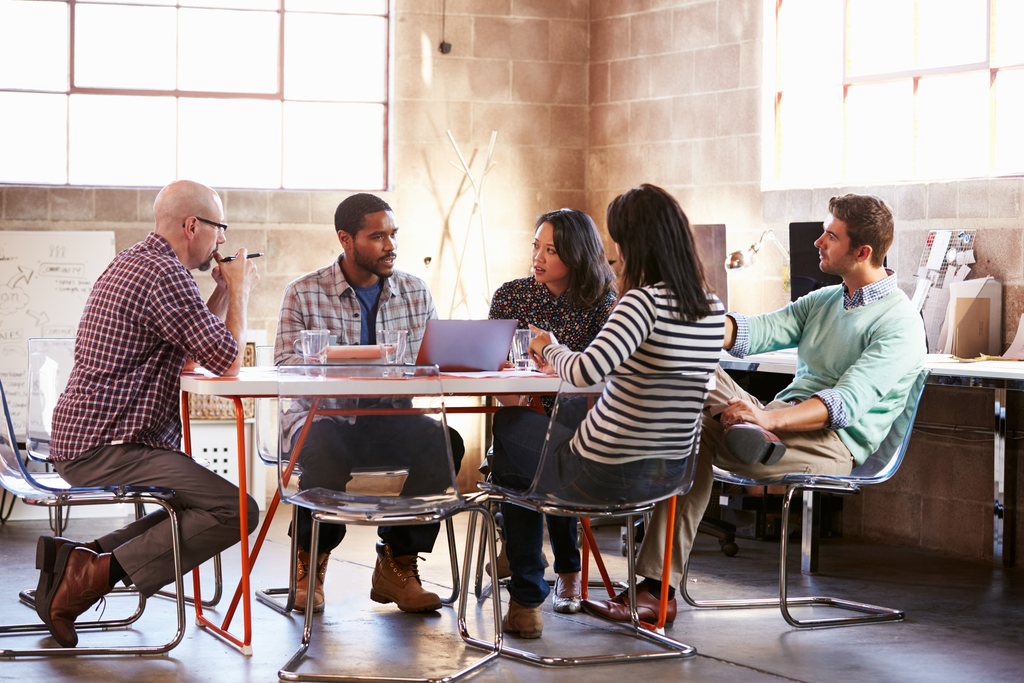 Brainstorming meeting around table in modern office