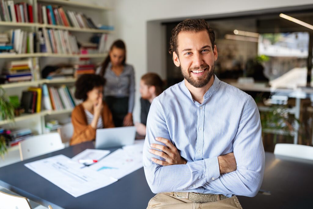 Portrait with business people in office behind