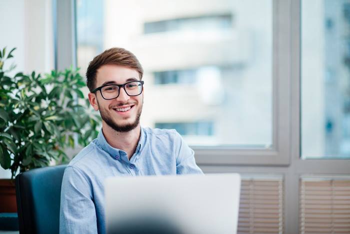 Businessman in office working on laptop
