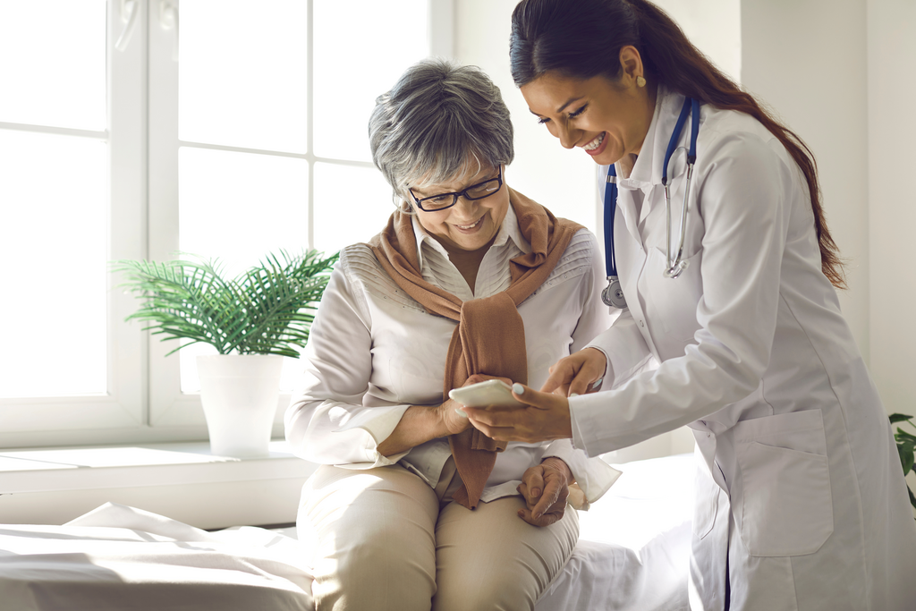 Doctor teaches patient to use mobile healthcare app
