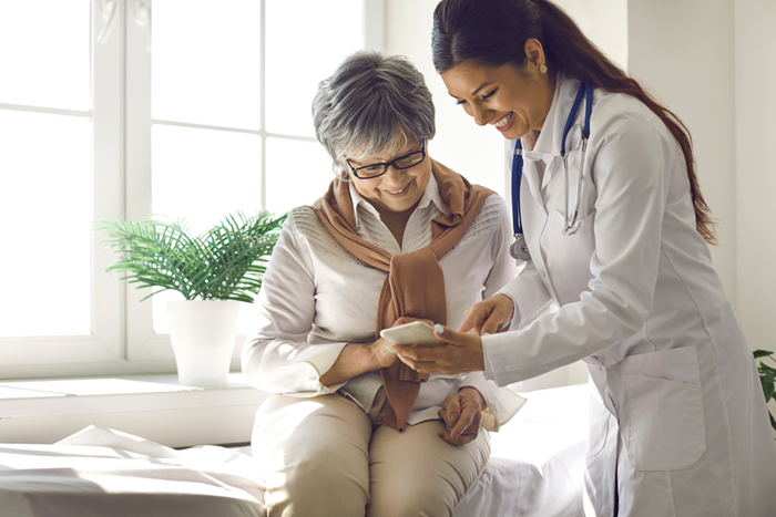 Doctor teaches patient to use mobile healthcare app
