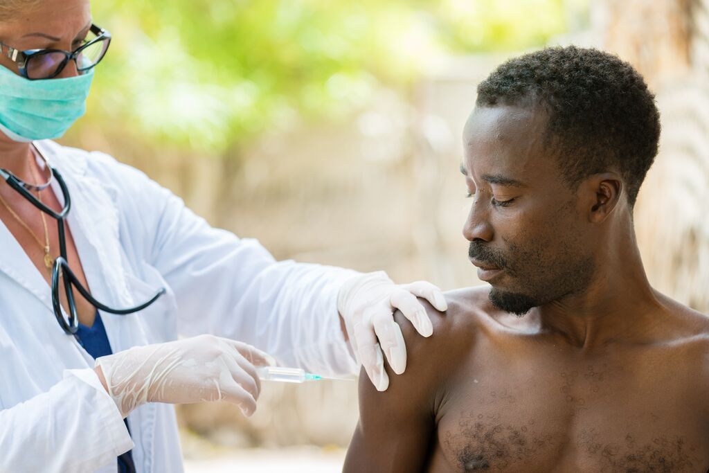 Vaccination of African man outdoors