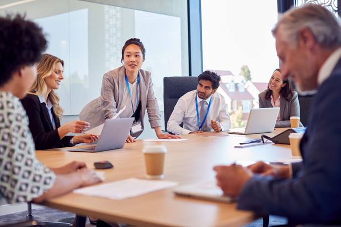 Businesswoman leading Team Meeting And Collaborating In Office