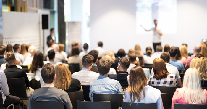 Speaker giving a talk in conference hall at business event Audience at