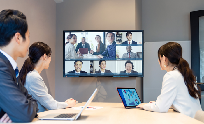 Team having online video call at office meeting room