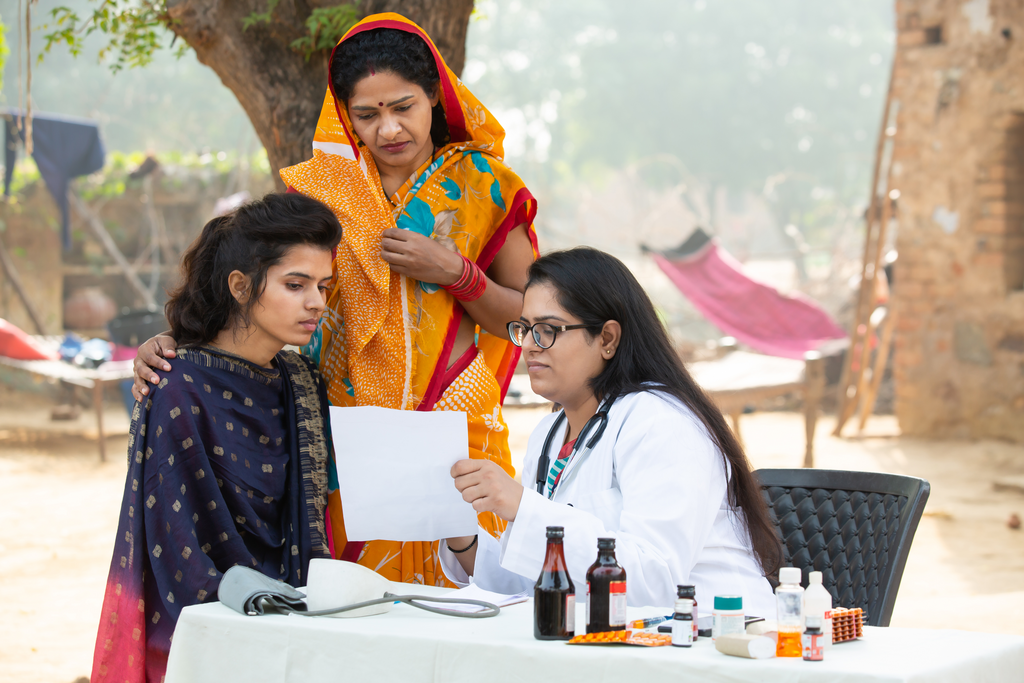 Indian adult girl with mother getting proscription medicine