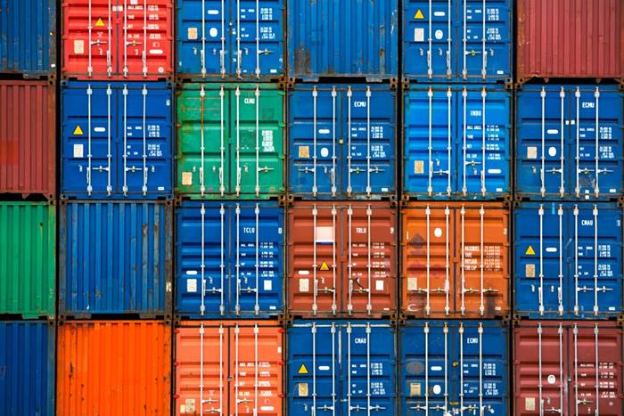 Four vertical rows of shipping containers