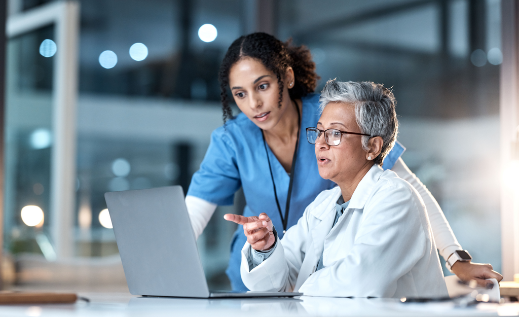 Doctor and nurse using laptop in hospital