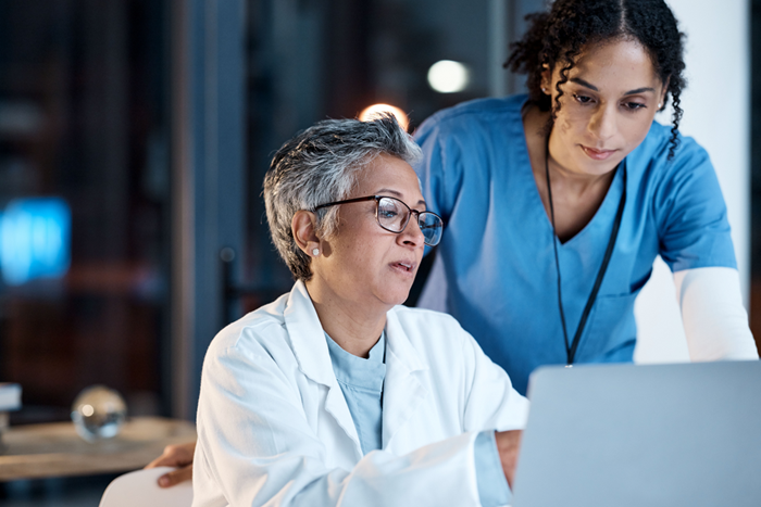 Doctor and nurse using laptop in hospital