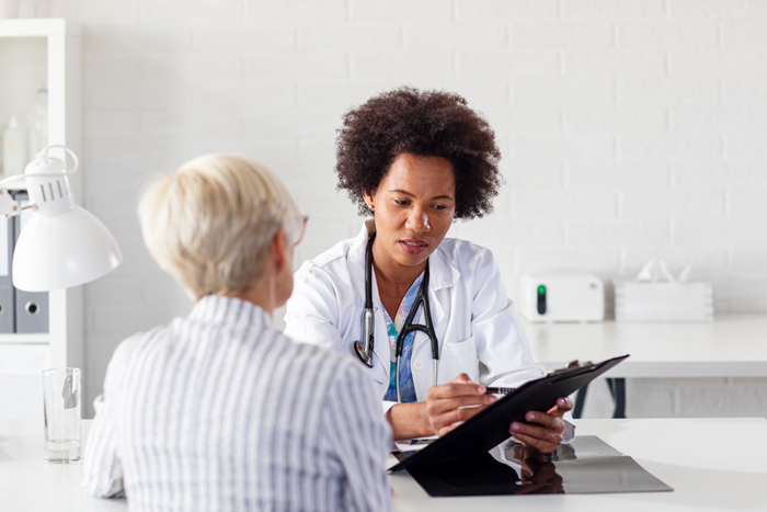 Patient with her doctor talking about healthcare