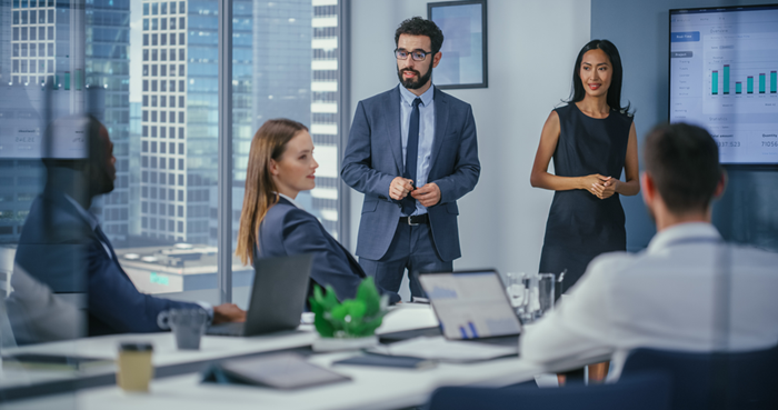 Team of Executives Present Statistics with Infographics Data