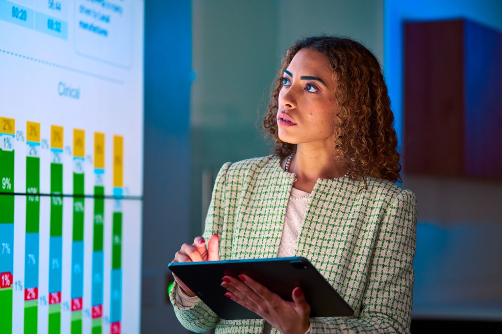 Custom Photo Female looking at data on screen while holding tablet
