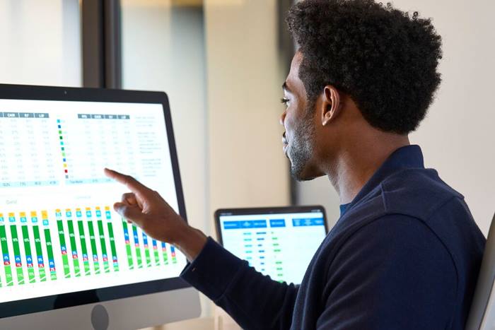 Custom Photo Male studying data on monitor