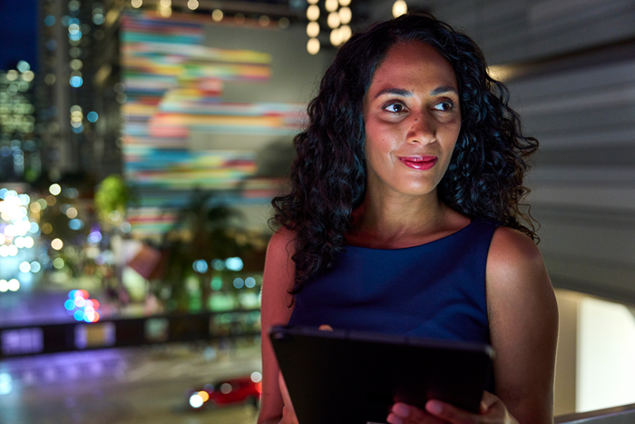 Custom Photo Female executive looking at tablet night setting