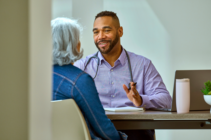 Custom Photo Doctor talking to an elderly patient