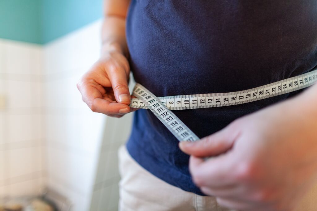 Man measures his abdomen