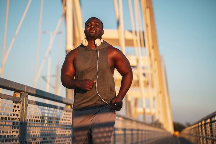 Young happy man jogging