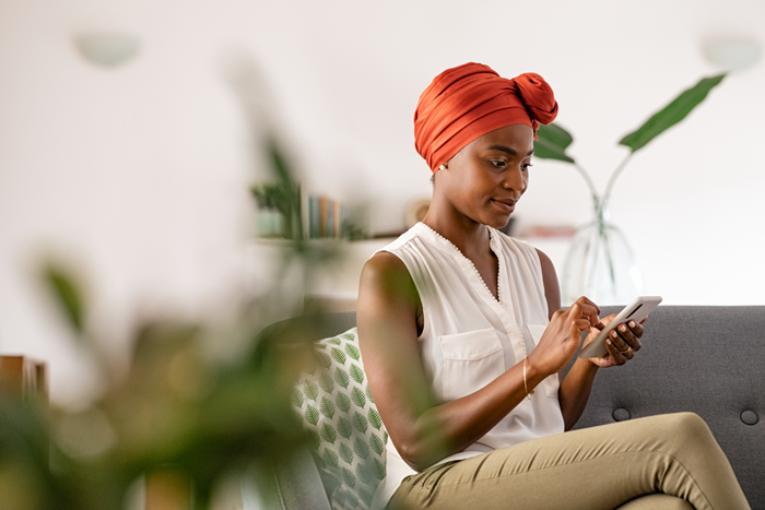 Mid adult woman using phone at home
