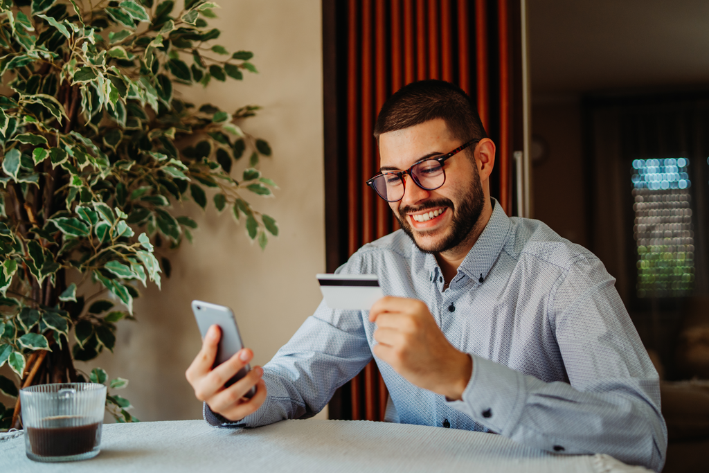 Young man shopping online on mobile phone