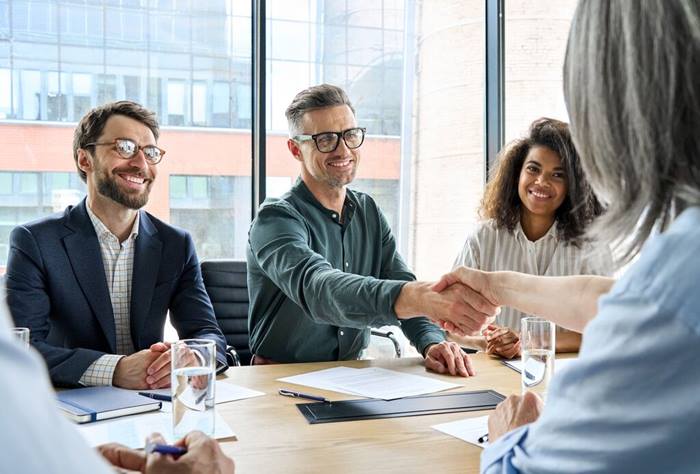 Businessman and businesswoman shaking hands
