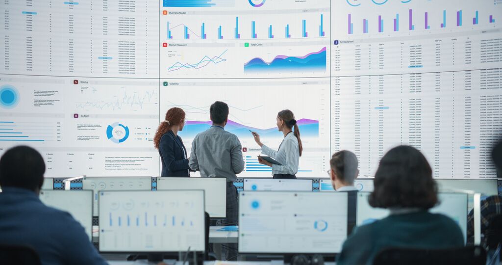 Diverse team of data scientists analyzing information on screen
