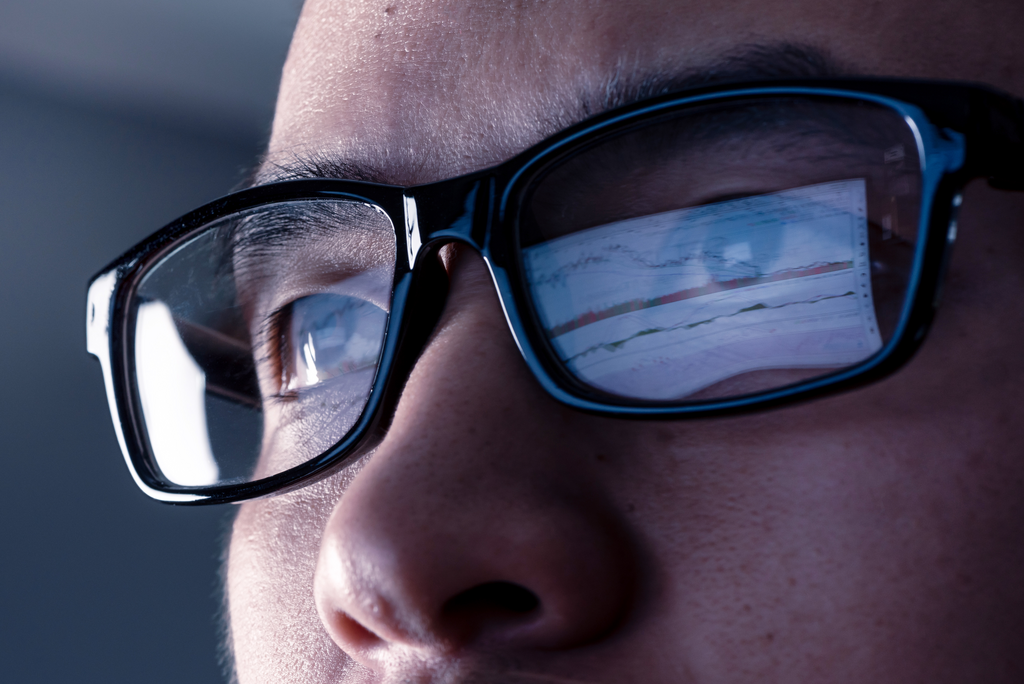 Website Featured Image PNG- Close up of man with computer screen reflection in his glasses