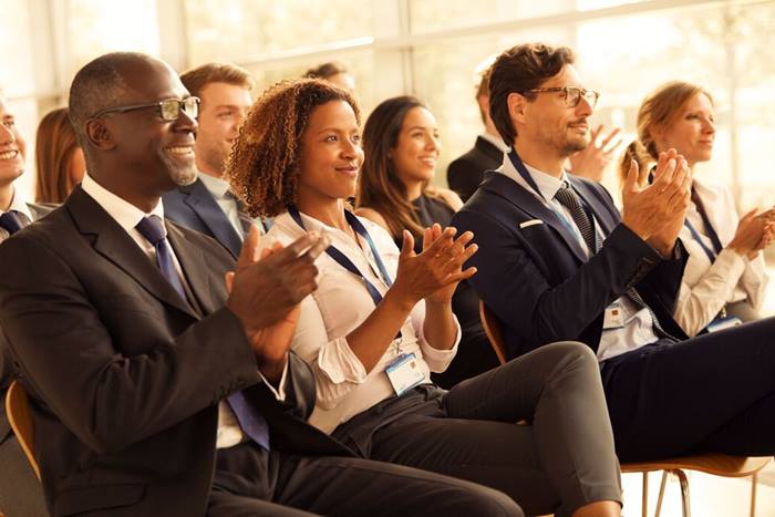 Website Featured JPG- Professionals applauding at a seminar